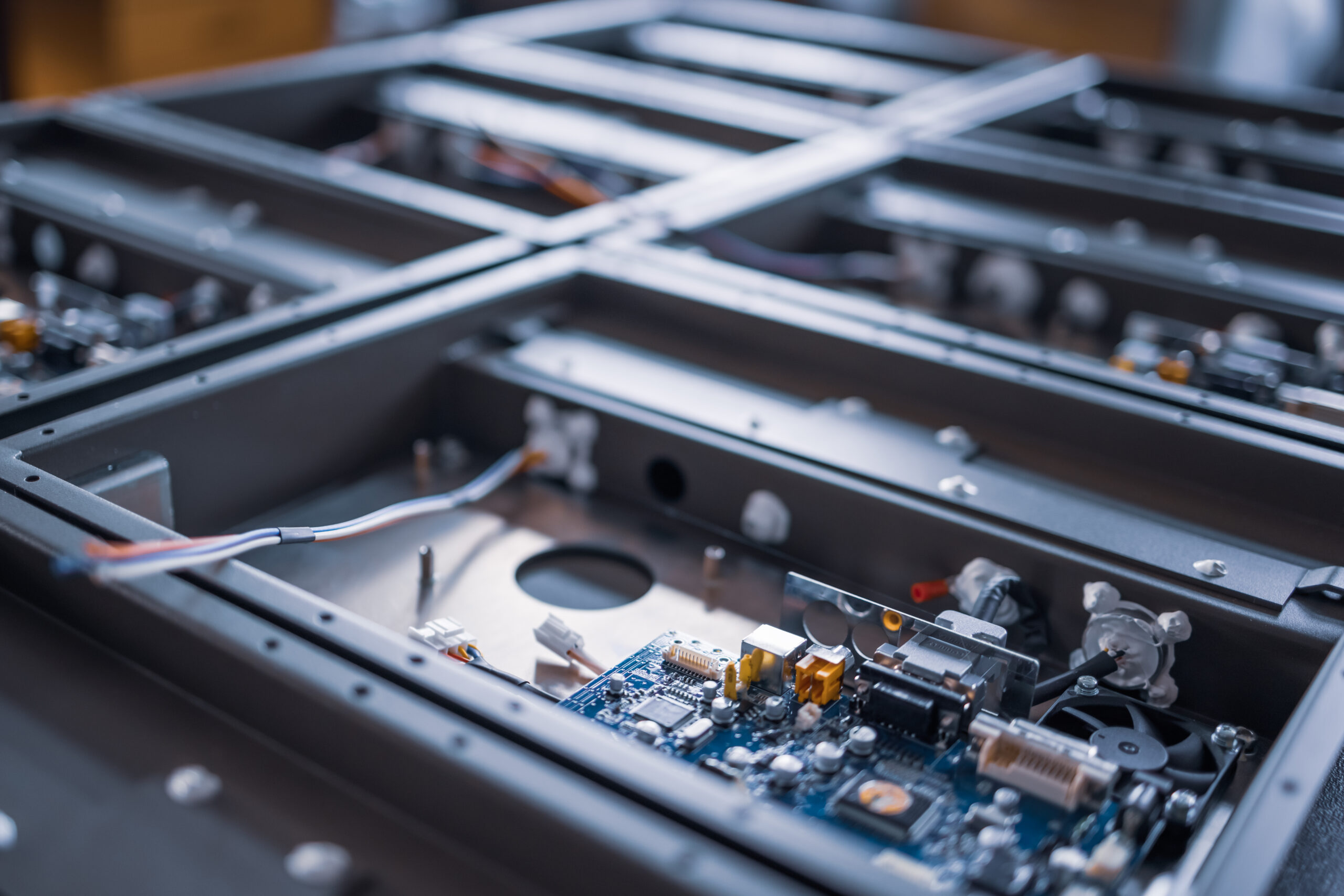 Metal components and microcircuits lie on metal compartments during the production of cases of future powerful supercomputers with video fruits. Concept production of specialized mining computers Metal components and microcircuits blanks in laboratory
